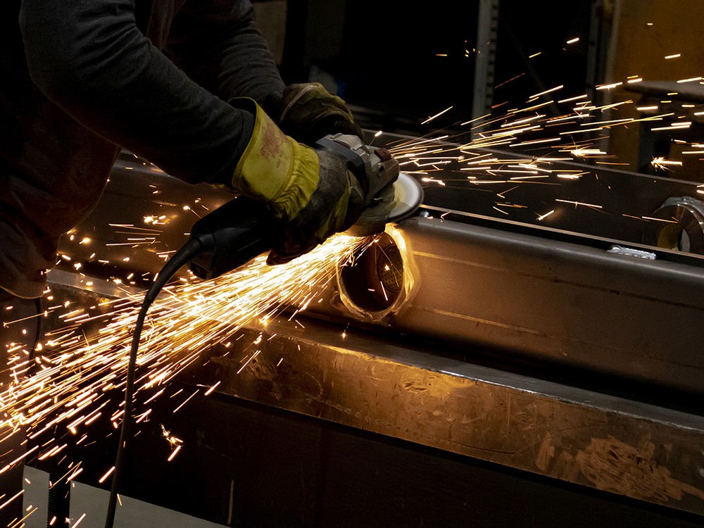 Employee Grinding a Large Component